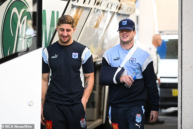 Mitchell Moses (right) broke the biceps of his beer-drinking hand during the win, but was all smiles with teammate Zac Lomax (left) despite the beer celebration on Thursday.