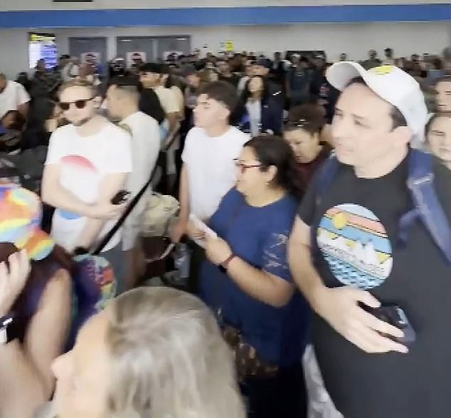 The clip, recorded by a nearby passenger, showed a huge crowd of passengers gathering around a gate as overwhelmed Spirit employees panicked