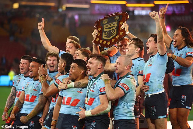 Mitchell, 27, was unable to play in the third match due to a foot injury but showed his support for Michael Maguire's team (pictured with the Origin shield) on Instagram