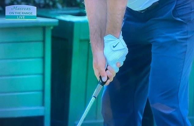 When warming up on the course, Scheffler uses a molded grip training aid to ensure his hand is placed correctly on the club