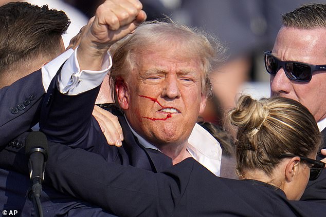 The former president, covered in blood from the bullet that grazed his ear, raises his fist during the event in Pennsylvania on Saturday