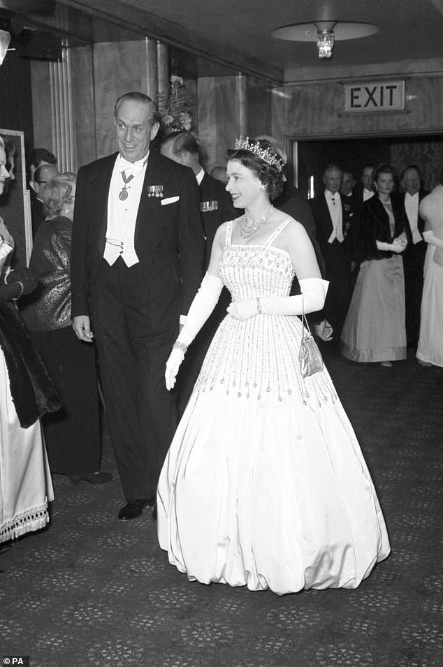 Queen Elizabeth II arrives at the Odeon, Leicester Square in 1962 wearing the same Norman Hartnell Peau De Soie taffeta dress that Princess Beatrice wore to her wedding