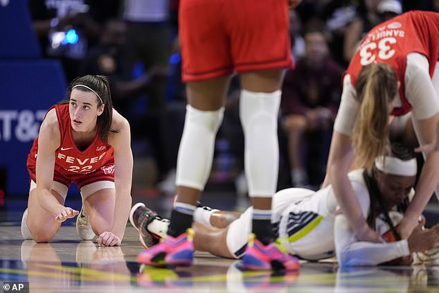 Clark, left, looks toward the bench after being stripped of the ball recovered by Sims