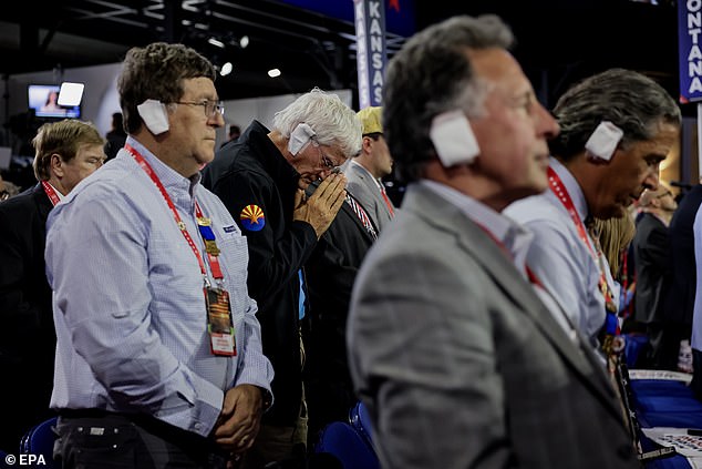 Delegates at the Republican National Convention in Milwaukee, Wisconsin, tie homemade bandages around their ears