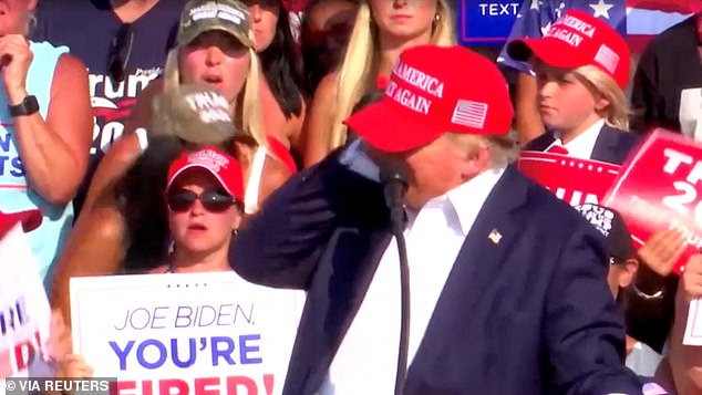 Republican presidential candidate and former US President Donald Trump responds after gunshots were heard during a campaign rally