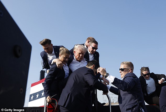 Republican presidential candidate and former President Donald Trump are carried off stage after being shot