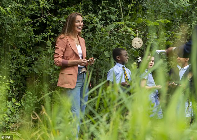 The then Duchess of Cambridge is spotted strolling through the museum gardens with a group of schoolchildren in June 2021