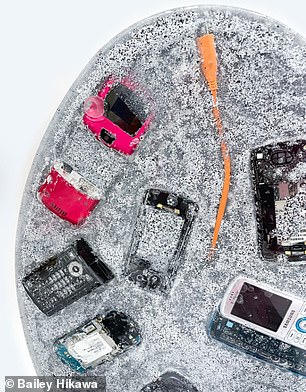 Her latest design consists of dozens of retro smartphones embedded in gray, speckled resin