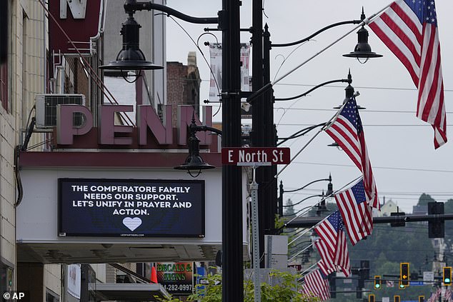 A memorial for Corey Comperatore is seen on a billboard at the Penn Theater in Butler, PA, Thursday, July 18, 2024