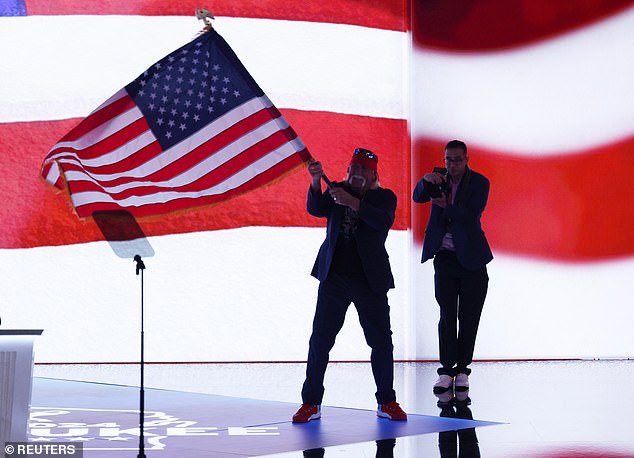 Hulk Hogan walked onto the stage holding an American flag after unmasking himself as a supporter of former President Donald Trump