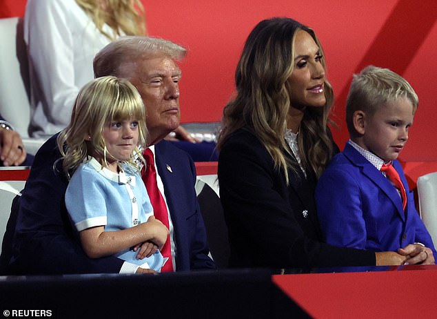 Republican presidential candidate and former US President Donald Trump, Lara Trump, Eric Luke Trump and Carolina Dorothy Trump look on