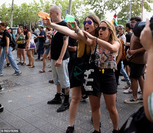 Protesters in Barcelona, Spain squirted water guns at foreign tourists along Las Ramblas and the city centre, which the Spanish government has condemned (pictured)