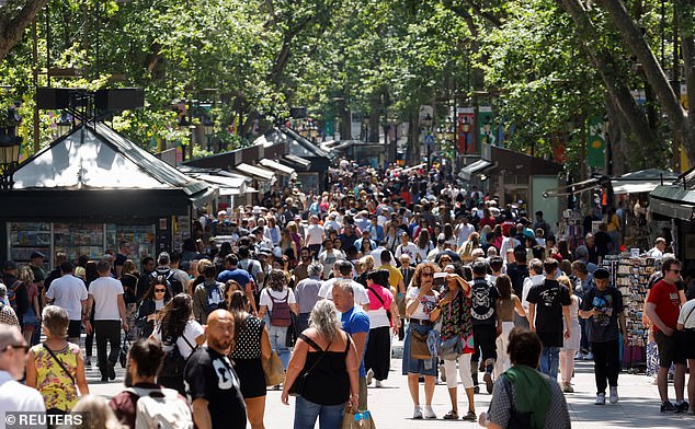 Locals in Barcelona protested on July 6 about how tourists have driven up housing prices and they could no longer afford to live in the city (pictured, the tourist hotspot of Las Ramblas)