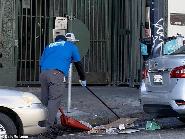 City workers are seen cleaning the streets and removing tents and belongings of the homeless