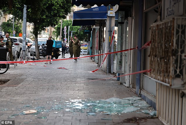 Shards of glass can be seen in the streets of Tel Aviv after the drone strike after the 'new' air weapon 'evaded interception systems'