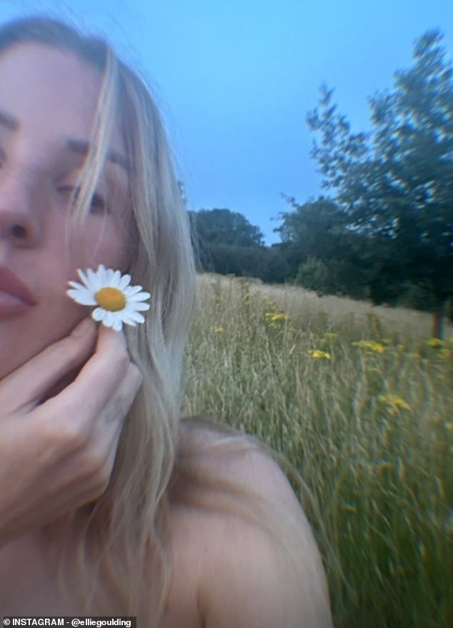 In a final photo, Ellie held a daisy to her cheek in a close-up selfie that showed half of her face and shoulders