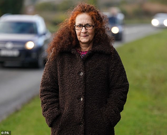 Elizabeth Donowho walks along the side of the road near the spot where the accident occurred last year