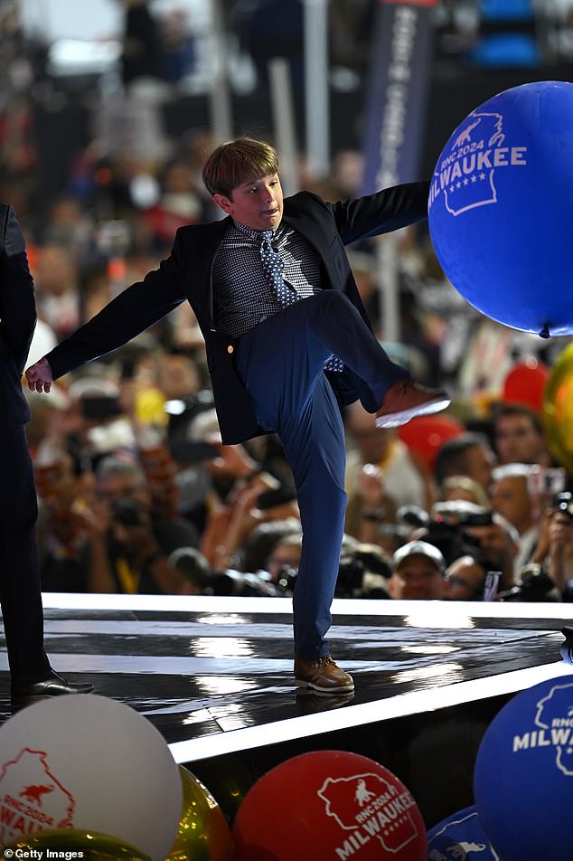 One of Trump's grandsons plays with balloons at the end of the Republican National Convention