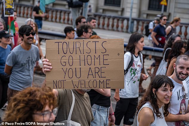 An anti-tourism placard is seen during an anti-tourism demonstration in Barcelona earlier this month. More than 3,000 people demonstrated against the overcrowding of tourists in the city of Barcelona and for policies to reduce tourism.