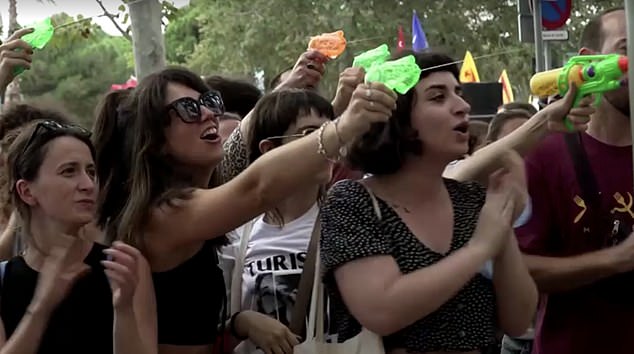 Protesters fired water pistols at tourists eating at popular spots in the city