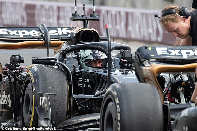 The World War Z star got ready for his practice lesson and looked in his element as he jumped into the race car