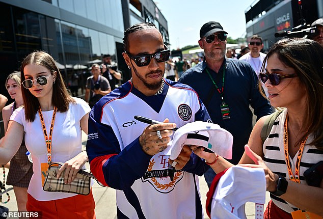 Lewis made sure to wear a silver chain and black square sunglasses