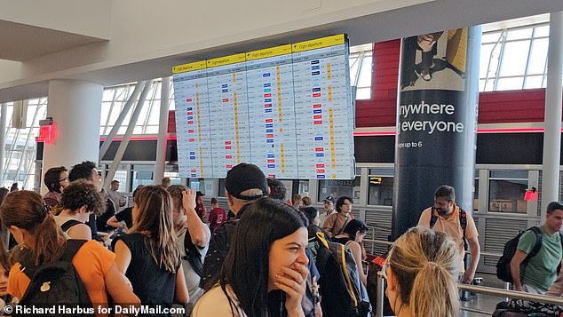 Images and footage from airports across the country showed weary travelers staring at blank screens, wondering if their flight would depart. Pictured are people waiting at JFK Airport in New York