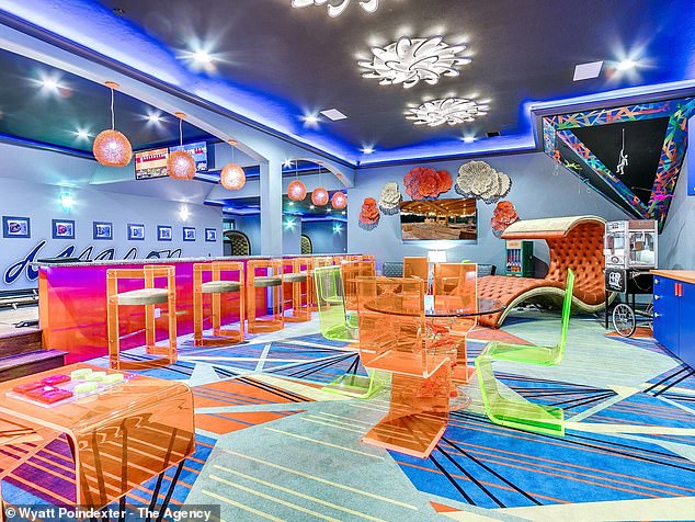 One of the most colorful rooms in the house is the bowling alley, which features transparent neon furniture, a fun patterned floor and cool lighting