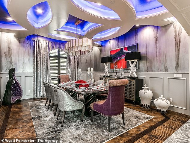 The dining room has a nice geometric ceiling with LED backlighting and marble walls