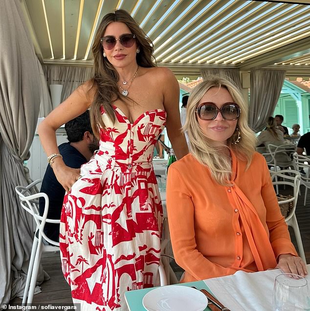 The Modern Family star looked elegant in a strapless red and white printed dress, a corseted top and an A-line skirt with pockets as she posed alongside pal Anastasia Soare, who looked chic in orange