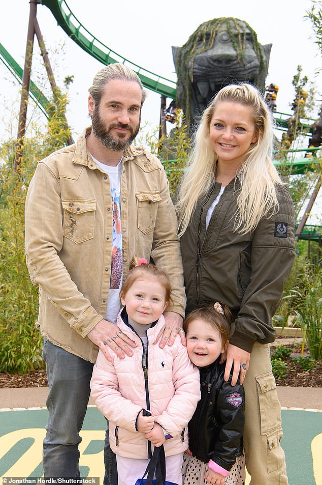 The 43-year-old S Club 7 star told The Sun: 'That's the dream, to move to Costa Rica and buy some land or a farm and have a simple life with the girls' (pictured with her partner Adam Thomas and their two girls)