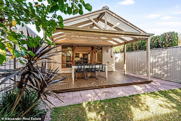 Located just 4km from the CBD, the two-storey pad features a beautiful open plan design and delightful timber finishes. Pictured: the charming veranda entertainment area