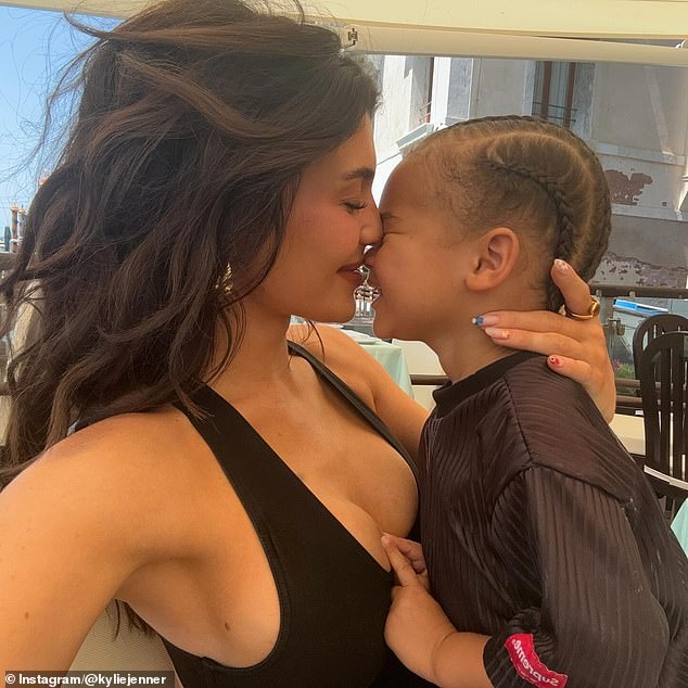 The 26-year-old makeup mogul posted photos of herself cuddling with her son, who she shares with ex-boyfriend Travis Scott, 33