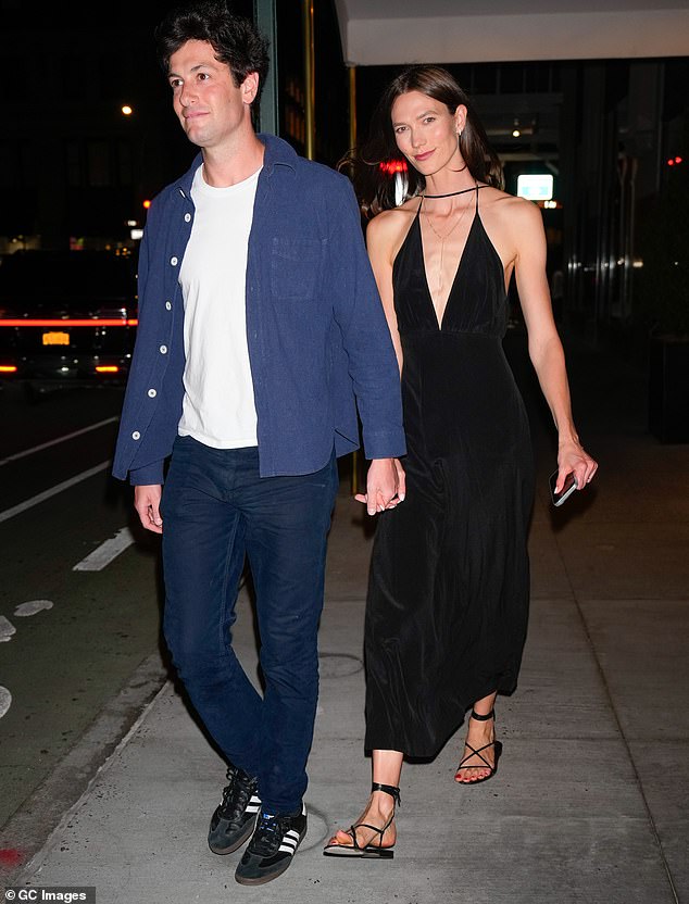 Karlie Kloss mirrored Huma's elegant aesthetic as she wore a plunging black dress while holding the hand of her husband Joshua Kushner