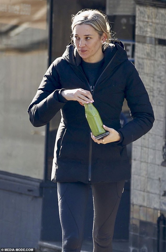 The designer had a big smile on her face as she walked, clutching a healthy green juice in a bottle