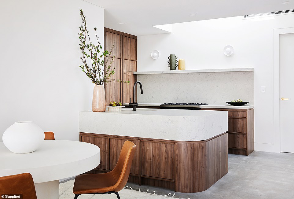 The kitchen is Mr. Scott’s (pictured) favorite part of the house. The curves throughout the house—including the countertops and the base of the stairs—make the space feel larger than it is.