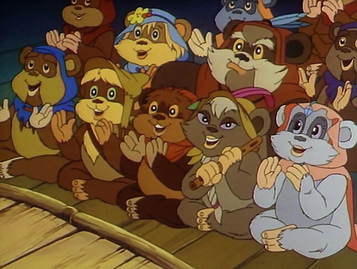 Ewoks clap at the front of a stage