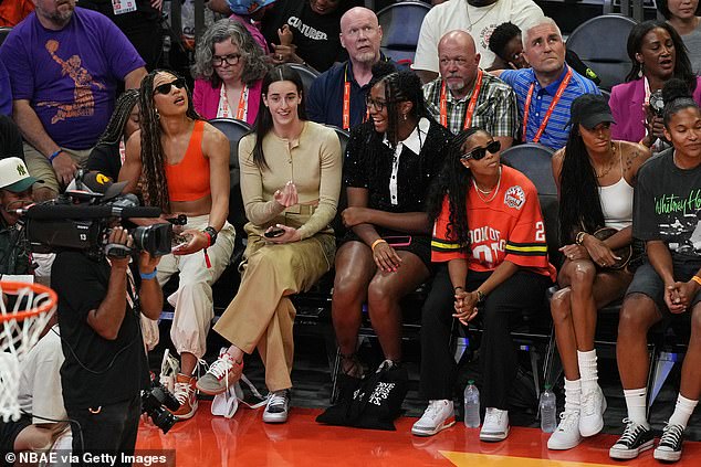 Clark watched from the sidelines with teammate Aaliyah Boston and other WNAB players