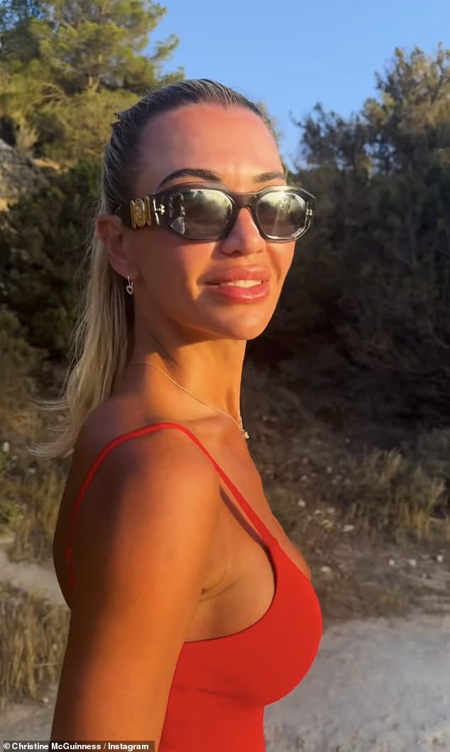 Meanwhile, Christine made sure temperatures rose in a red swimsuit as she soaked up the sun in Ibiza with musician Roxxxan