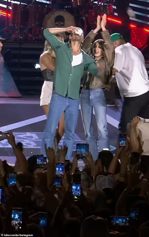 1721526851 255 Glen Powell chugs a beer on stage at Luke Combs