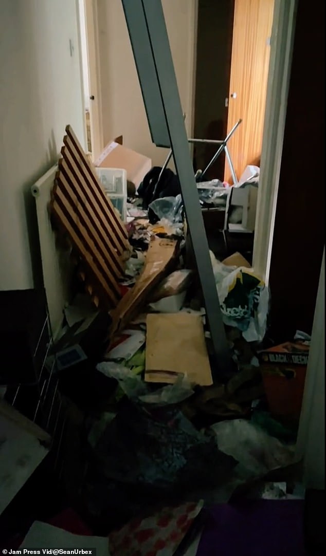 The hallway was blocked by piles of trash, making it impossible to walk through