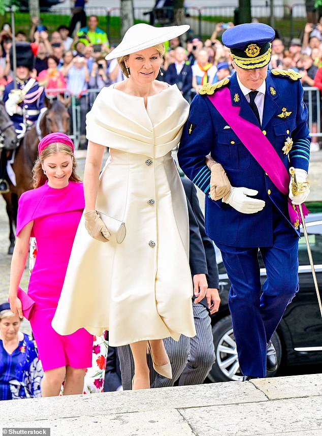 Queen Mathilde, 51, was stylish in an ivory button-down dress with a full skirt and matching hat and gloves