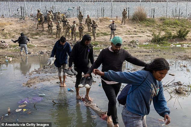 The Texas National Guard is conducting an operation using non-lethal weapons, specifically a pepper spray gun, to disperse migrants maintaining a camp in the Rio Grande on the Mexico-United States border in Ciudad Juarez.