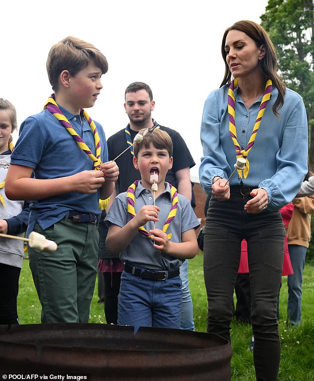 George, Louis and Kate, dressed in matching casual attire, enjoy roasting marshmallows over a fire at Big Help Out