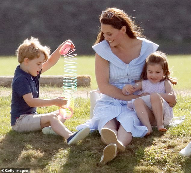 Prince George practices tricks with a rainbow slinky as his mother Kate and sister Charlotte laugh during the Maserati Royal Charity Polo Trophy at Beaufort Polo Club in 2018