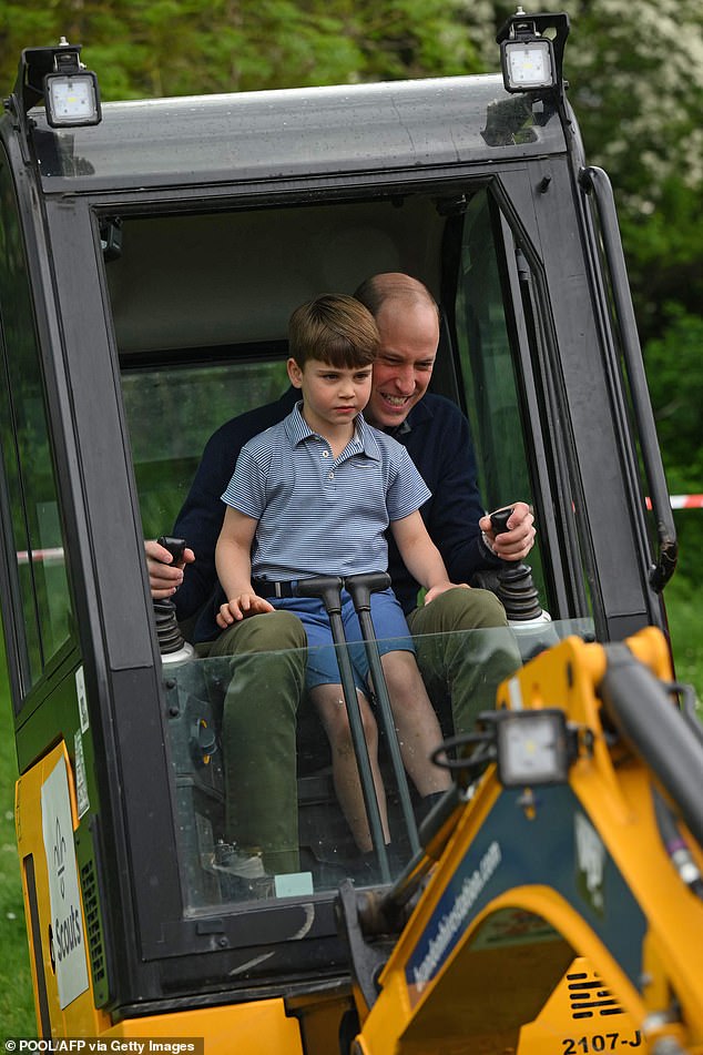 Prince William is assisted by his youngest son Louis as he uses a digger during his participation in last year's Big Help Out