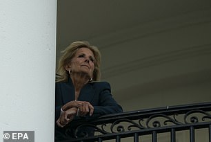 Jill Biden keeps an eye on Joe Biden from the Truman Balcony in the White House