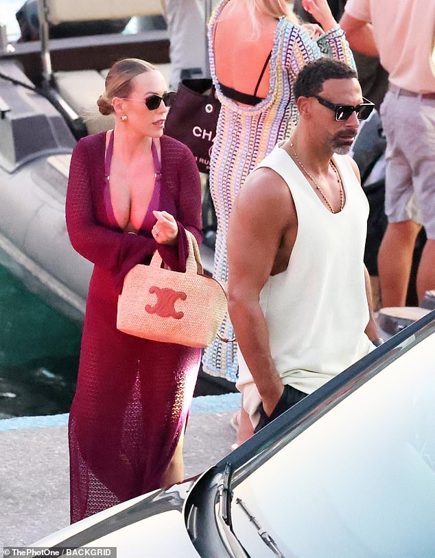 Kate looked effortlessly chic in a bikini in a matching dark purple cover-up, paired with her Hermes beach bag