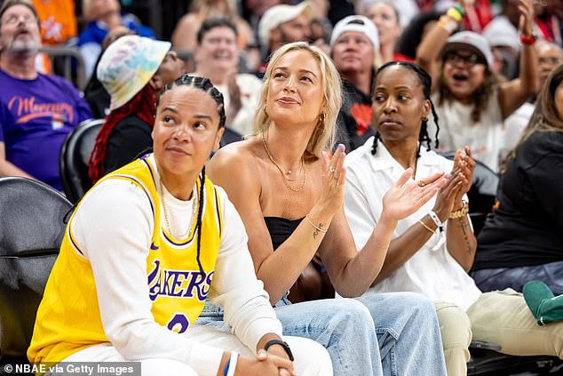 Cunningham watched the game with Kristi Tolliver (left) and LA Sparks defenseman Crystal Dangerfield (right)