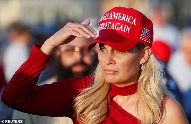 A supporter of Republican presidential candidate and former U.S. President Donald Trump looks on as he wears a MAGA hat at Ted Hendricks Stadium prior to Trump's campaign event in Hialeah, Florida, U.S., November 8, 2023